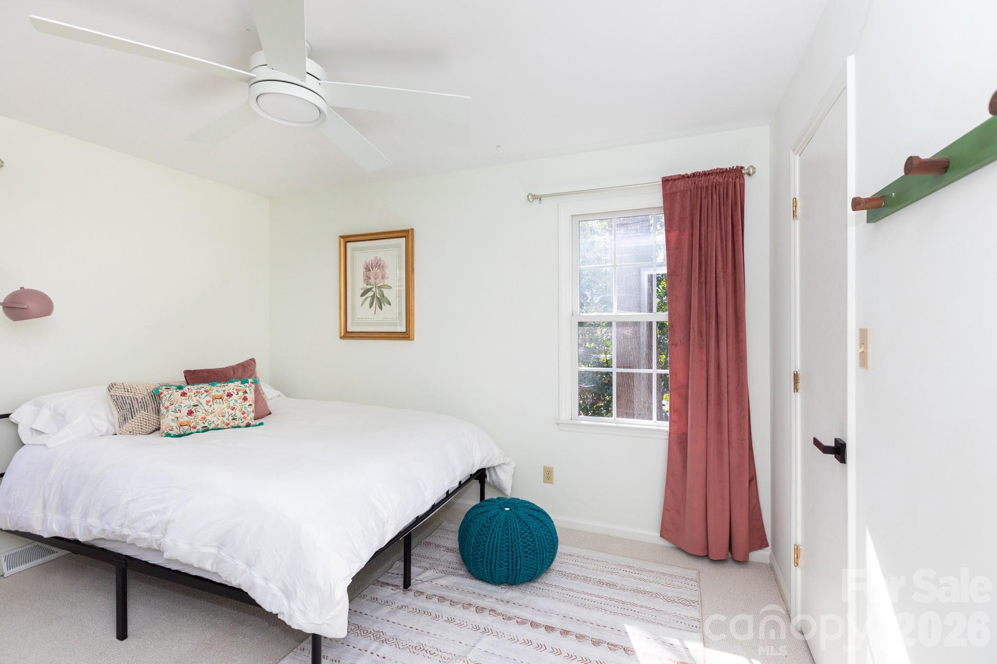 7423 Kuck Road Mint Hill, NC 28227 - Photo 20 of 31 a bedroom with a bed and a chandelier