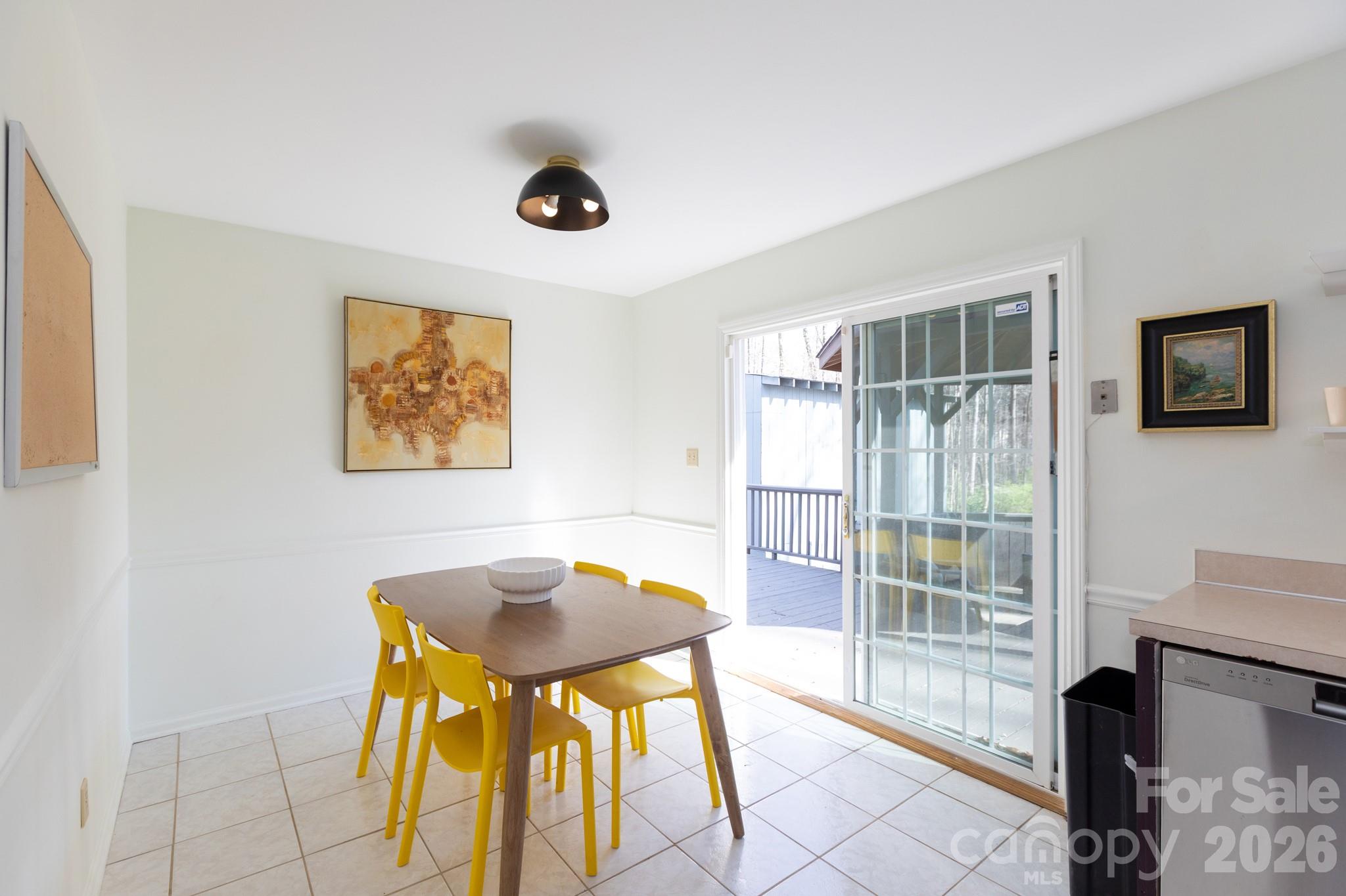 7423 Kuck Road Mint Hill, NC 28227 - Photo 22 of 31 a view of a dining room with furniture and a floor to ceiling window