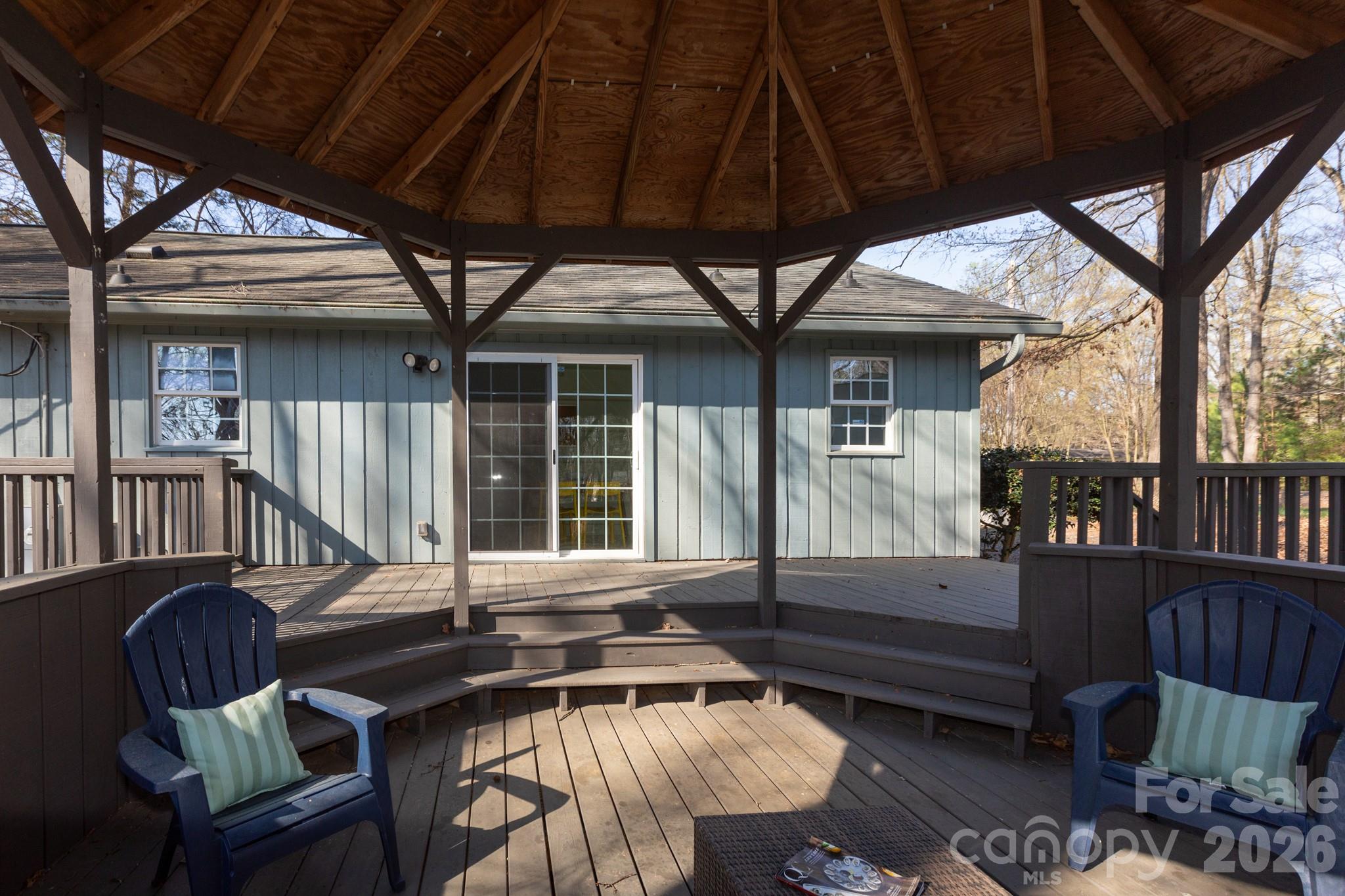 7423 Kuck Road Mint Hill, NC 28227 - Photo 25 of 31 a view of a patio with table and chairs and wooden floor