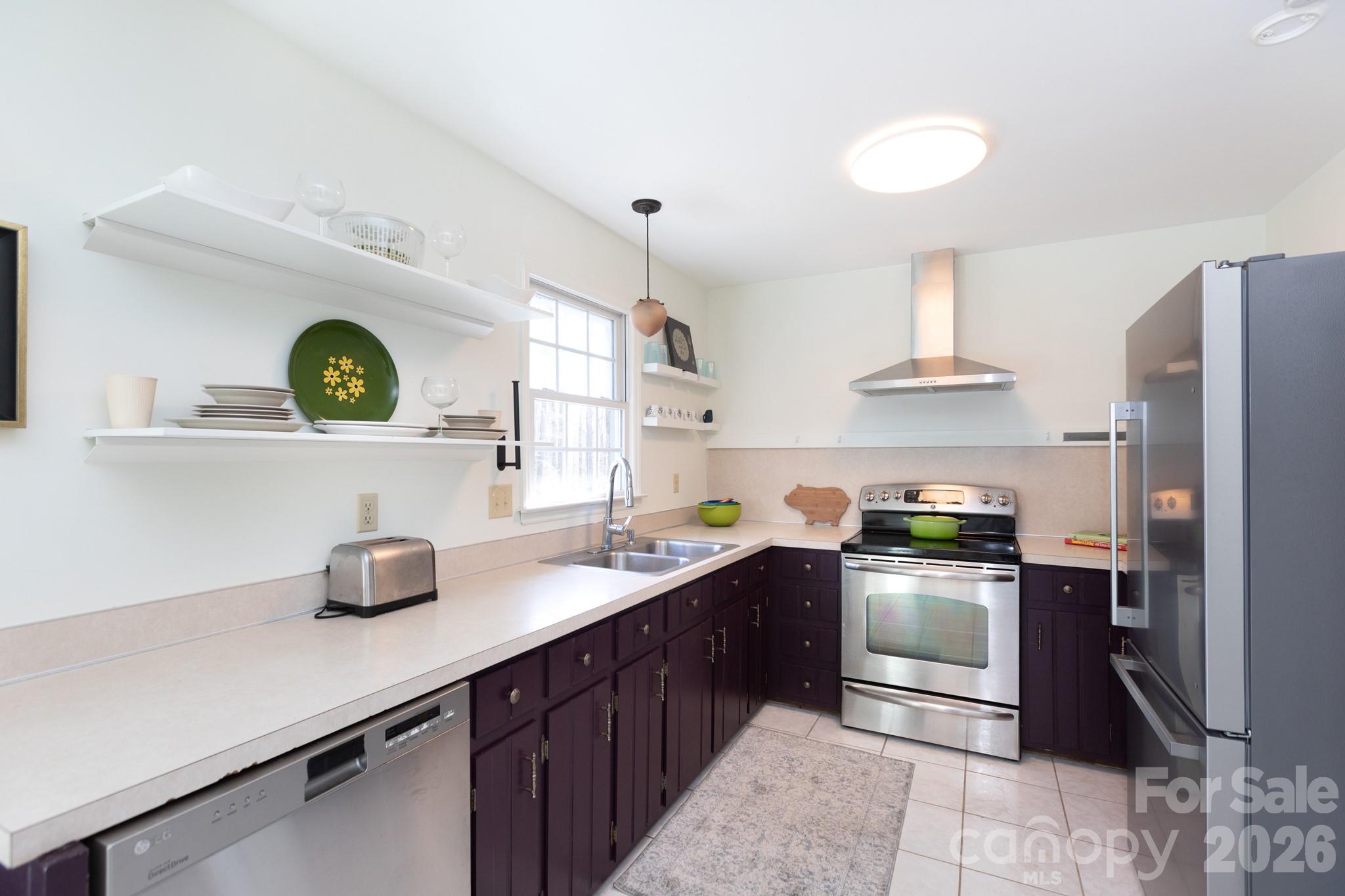 7423 Kuck Road Mint Hill, NC 28227 - Photo 8 of 31 a kitchen with stainless steel appliances granite countertop a sink a stove and refrigerator