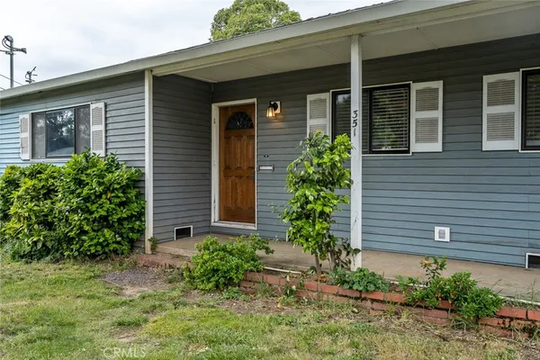 a front view of a house with plants