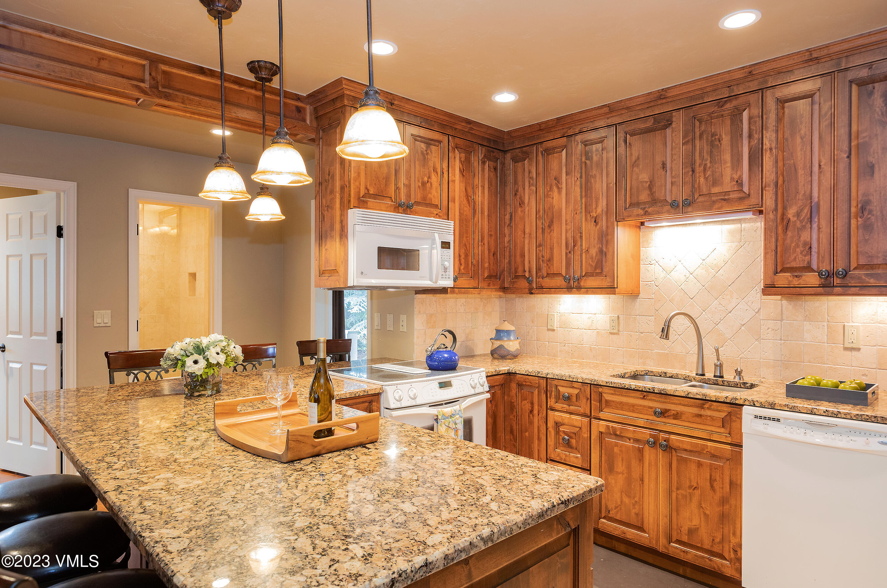 10 Stetson Drive, Unit A Edwards, CO 81632 - Photo 7 of 26 a kitchen with kitchen island granite countertop a sink and cabinets