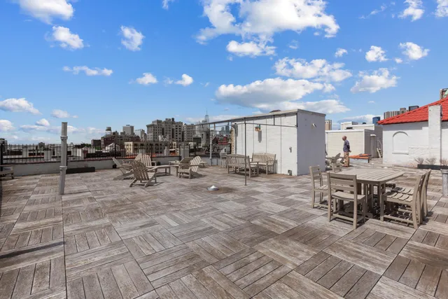 a view of a patio with dining table and chairs with wooden floor
