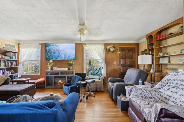 a living room with furniture or couch and a bookshelf
