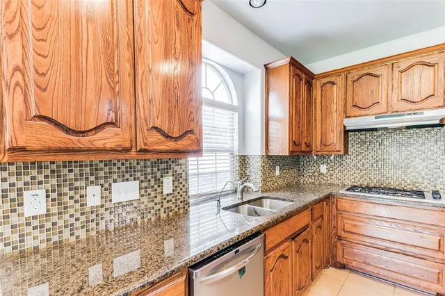 a open kitchen with stainless steel appliances granite countertop a stove and a sink