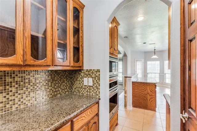 a kitchen with stainless steel appliances granite countertop a stove and a microwave