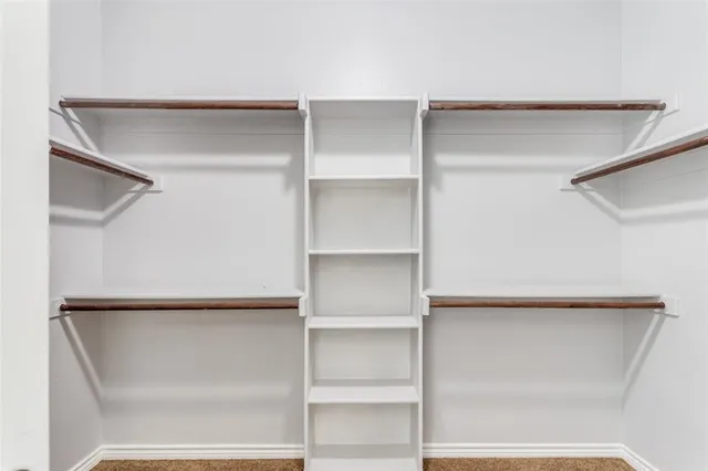 a bathroom with a granite countertop tub sink and mirror