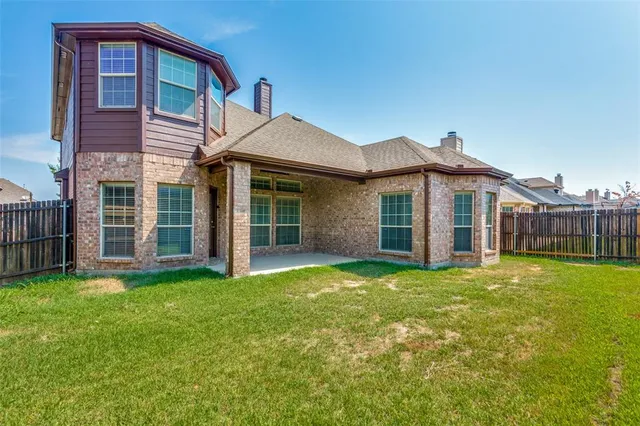 a view of a house with a yard and deck