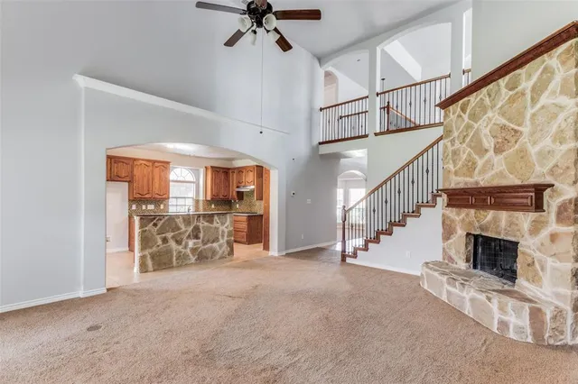 a view of entryway and hall with a fireplace