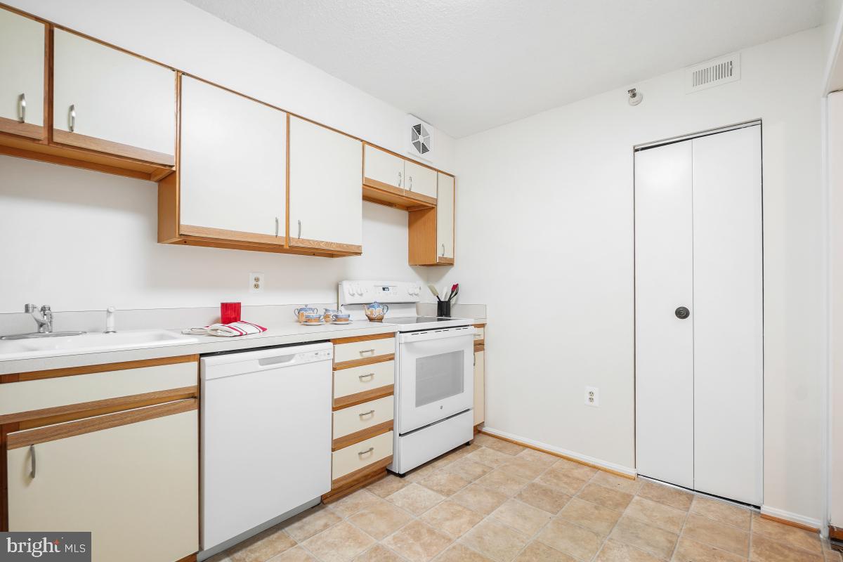 15107 Interlachen Drive, Unit 2321 Silver Spring, MD 20906 - Photo 19 of 35 a kitchen with sink cabinets and stove