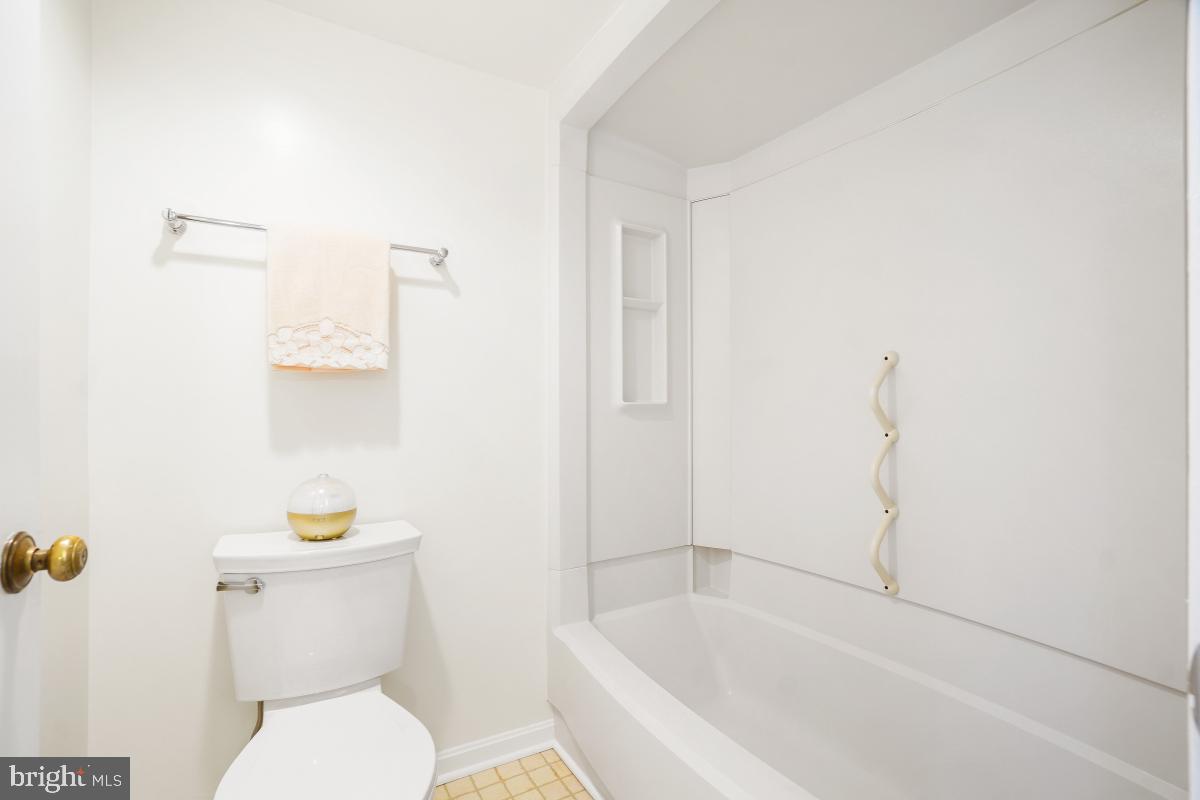 15107 Interlachen Drive, Unit 2321 Silver Spring, MD 20906 - Photo 28 of 35 a white toilet sitting next to a bath tub