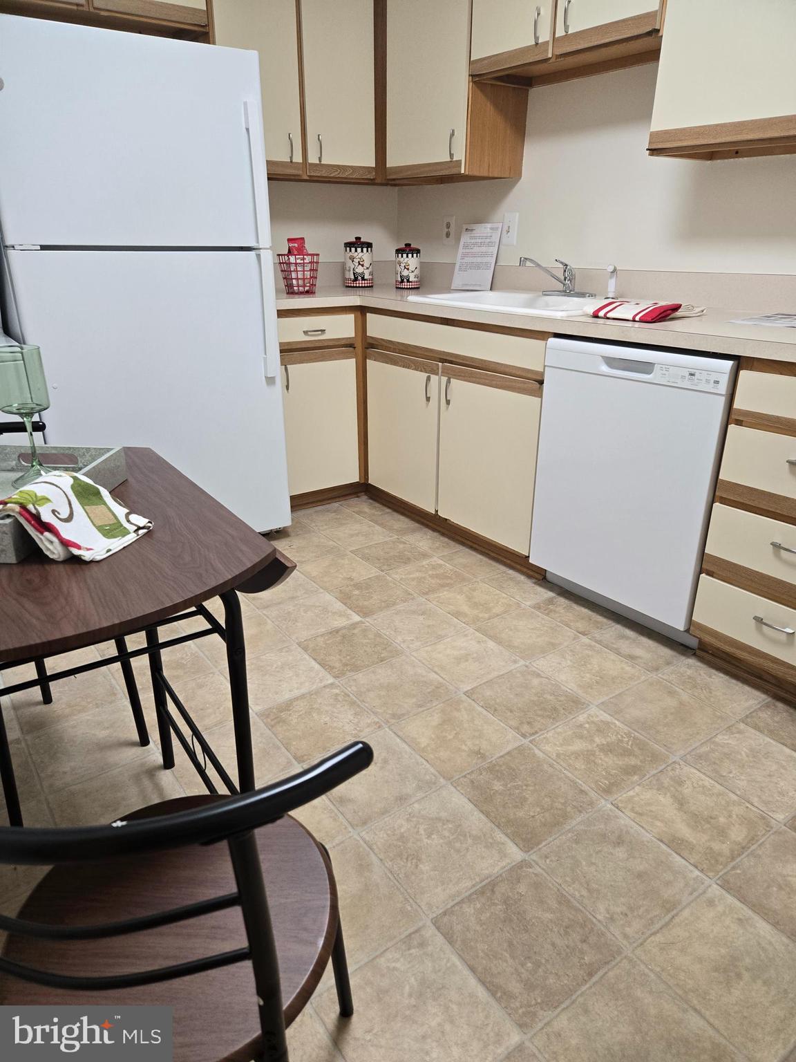 15107 Interlachen Drive, Unit 2321 Silver Spring, MD 20906 - Photo 3 of 35 a kitchen with a sink appliances and cabinets