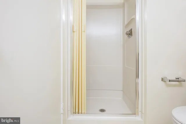 a bathroom with a glass shower door
