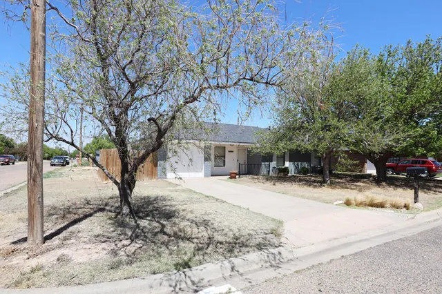 a view of a house with snow on the road