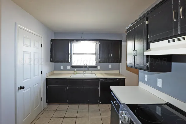 a kitchen with stainless steel appliances granite countertop a sink and a stove