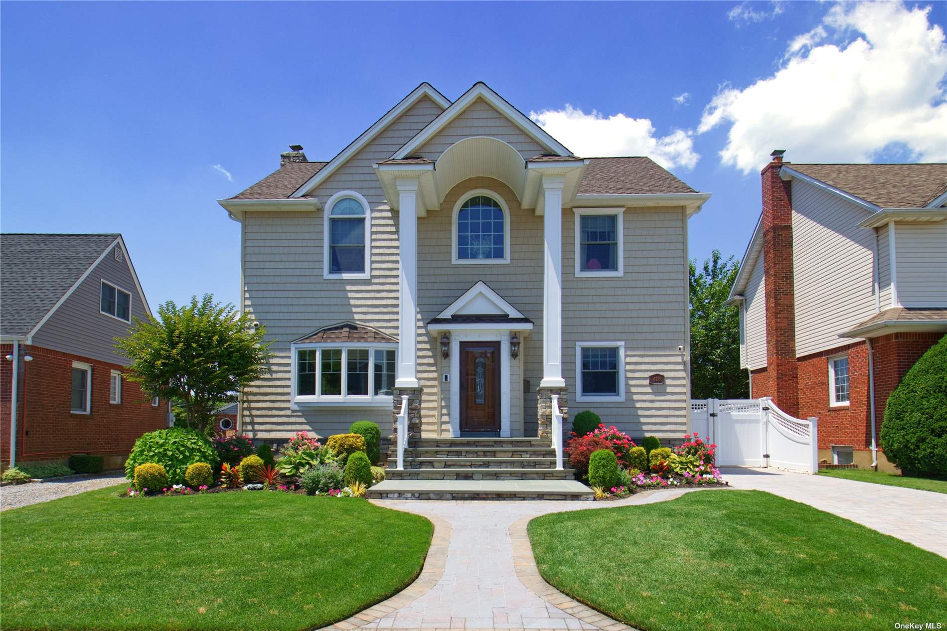 418 St John Place Franklin Square, NY 11010 - Photo 1 of 1 a front view of a house with a garden and plants