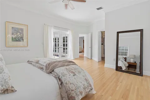 a spacious bedroom with a bed and a walk in closet