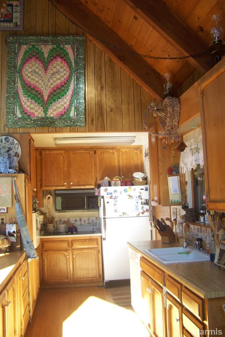 760 Hot Springs Road Markleeville, CA 96120 - Photo 23 of 28 a kitchen with stainless steel appliances granite countertop a stove and a wooden cabinets