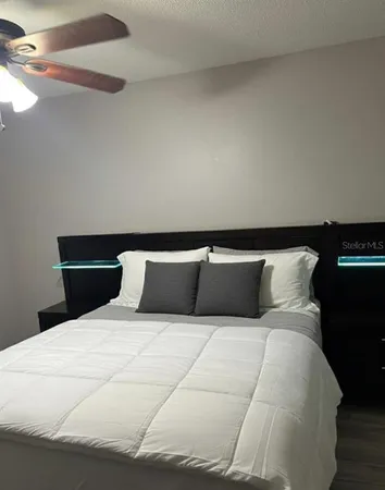 a bedroom with a bed and a dresser