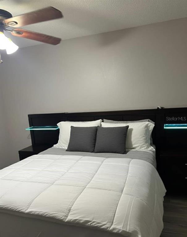 1057 South Hiawassee Road, Unit 1918 Orlando, FL 32835 - Photo 11 of 26 a large bed sitting in a bedroom and lamp