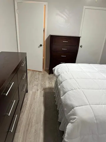 a bedroom with a bed and a flat screen tv