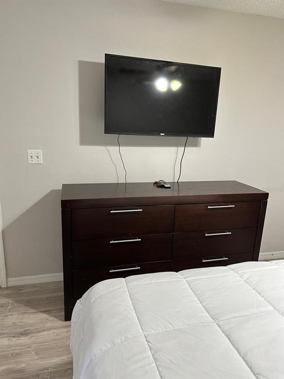 1057 South Hiawassee Road, Unit 1918 Orlando, FL 32835 - Photo 13 of 26 a bedroom with a bed and a flat screen tv
