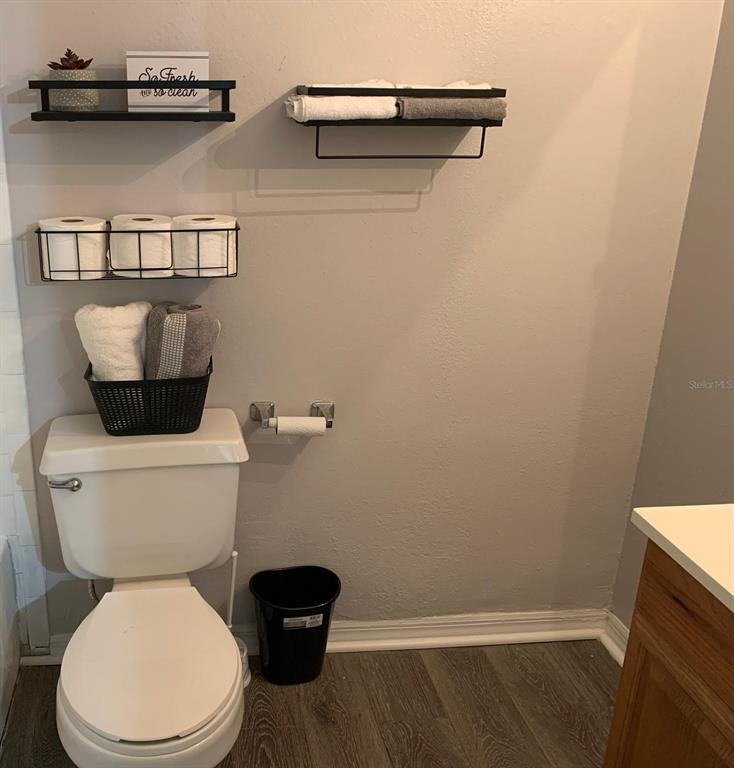 1057 South Hiawassee Road, Unit 1918 Orlando, FL 32835 - Photo 15 of 26 a white toilet sitting next to a bathroom sink