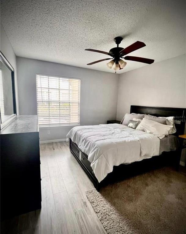 1057 South Hiawassee Road, Unit 1918 Orlando, FL 32835 - Photo 16 of 26 a bedroom with a bed and a window
