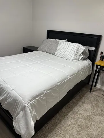 a bedroom with a bed and a chandelier