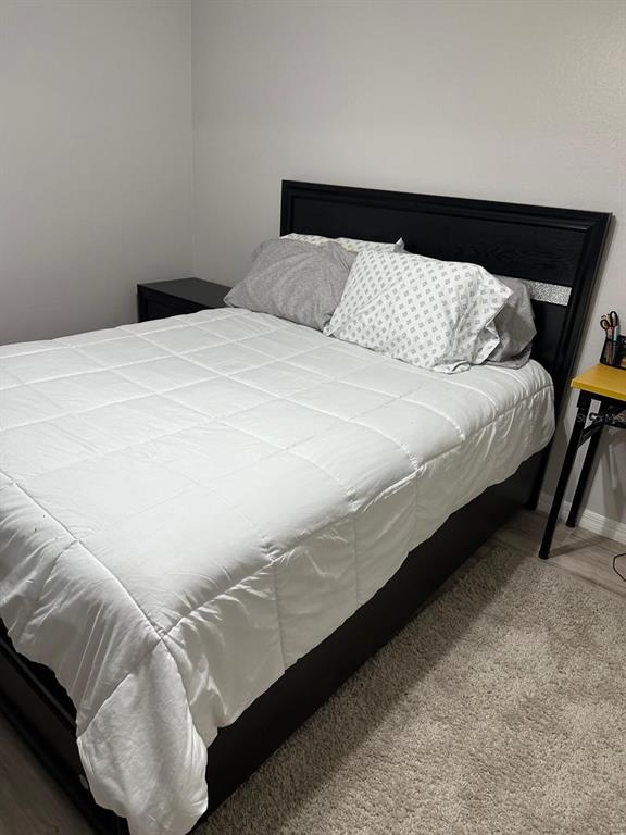 1057 South Hiawassee Road, Unit 1918 Orlando, FL 32835 - Photo 18 of 26 a bedroom with a bed and a night stand