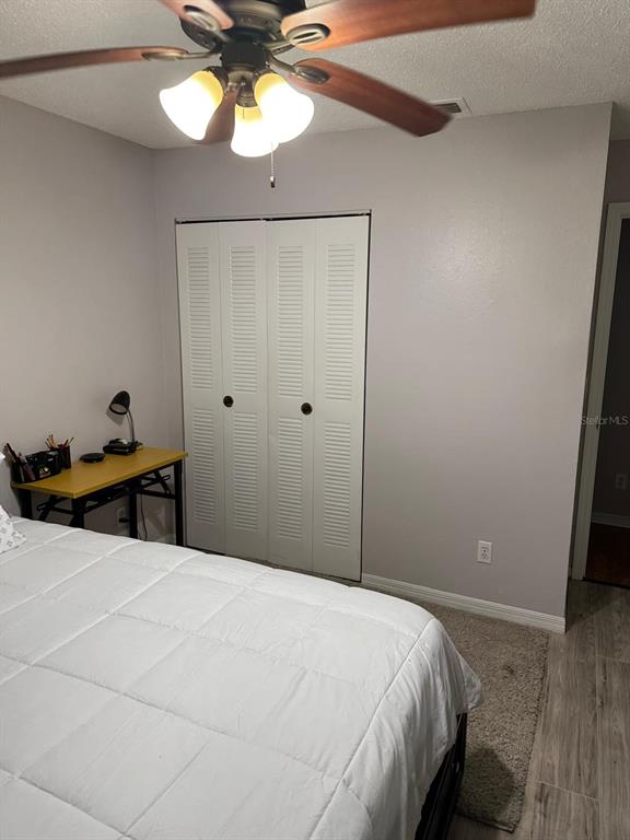 1057 South Hiawassee Road, Unit 1918 Orlando, FL 32835 - Photo 19 of 26 a bedroom with a bed and a chandelier