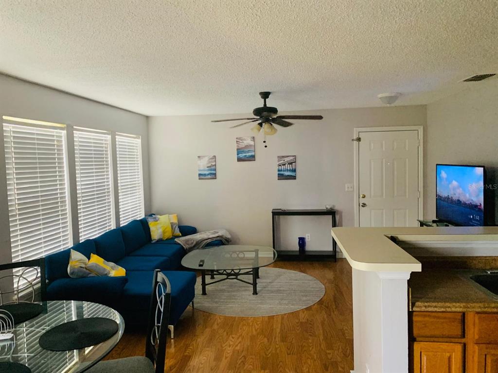 1057 South Hiawassee Road, Unit 1918 Orlando, FL 32835 - Photo 2 of 26 a living room with furniture and a window