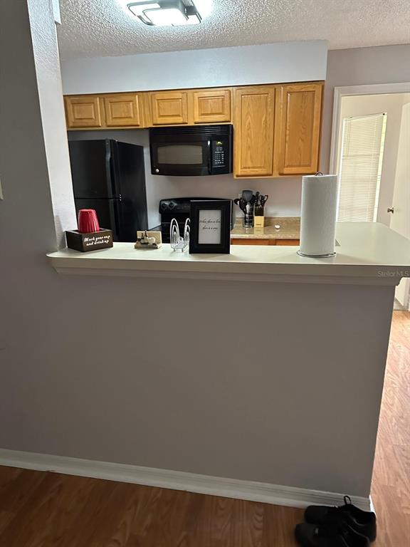 1057 South Hiawassee Road, Unit 1918 Orlando, FL 32835 - Photo 6 of 26 a kitchen with a sink and a microwave