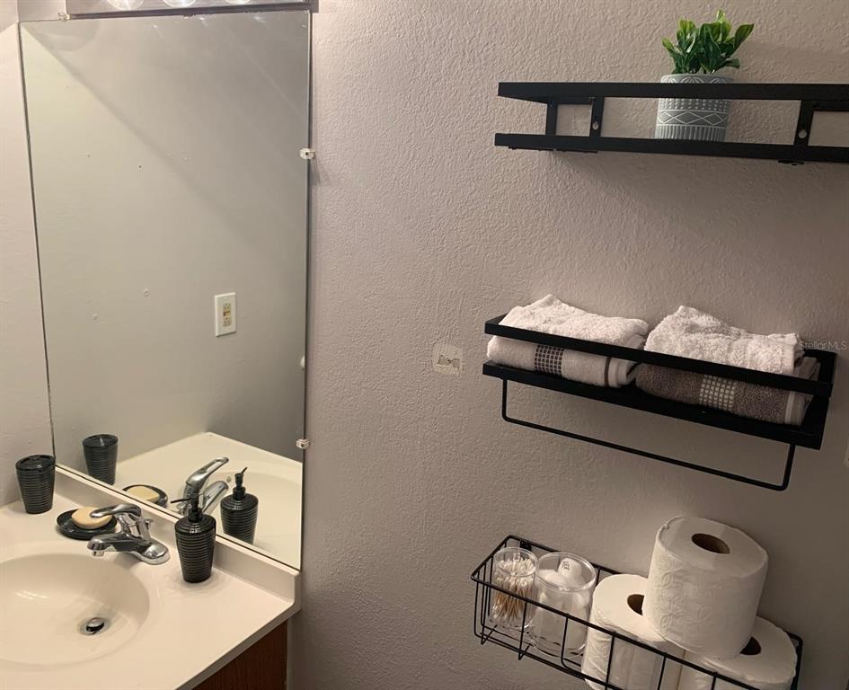 1057 South Hiawassee Road, Unit 1918 Orlando, FL 32835 - Photo 8 of 26 a bathroom with a sink and a mirror
