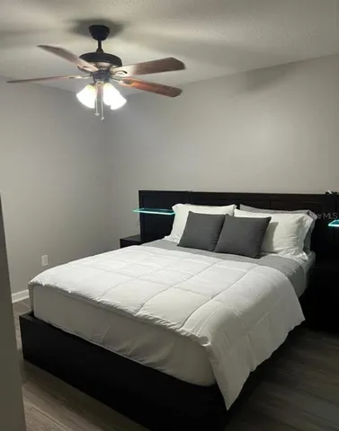 a large bed sitting in a bedroom and lamp