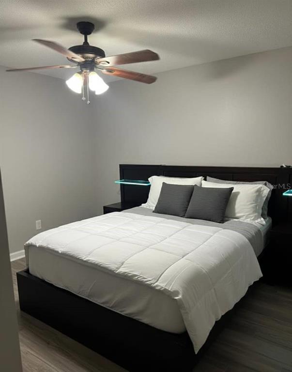 1057 South Hiawassee Road, Unit 1918 Orlando, FL 32835 - Photo 10 of 26 a bedroom with a bed and a chandelier