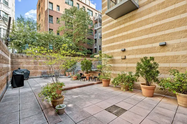 a view of a patio with table and chairs and potted plants