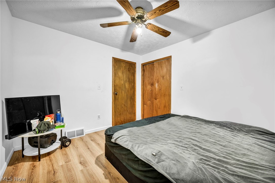 4560 Arrow Road Northwest Carrollton, OH 44615 - Photo 20 of 41 Bedroom with ceiling fan and light hardwood / wood-style flooring