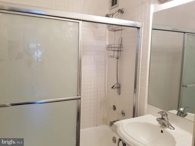a bathroom with a shower and a sink