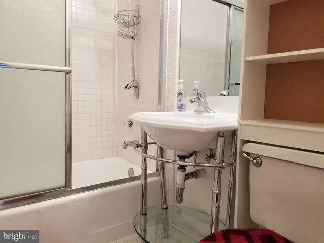 a bathroom with a sink mirror and a bathtub