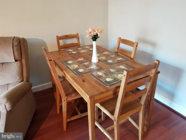 a dining room with furniture and wooden floor
