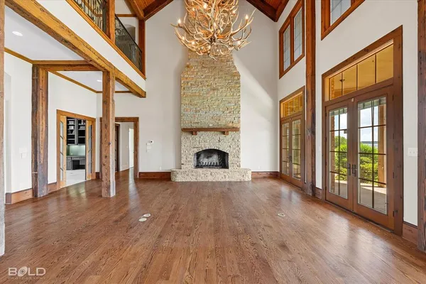 a view of a livingroom with wooden floor a fireplace and window
