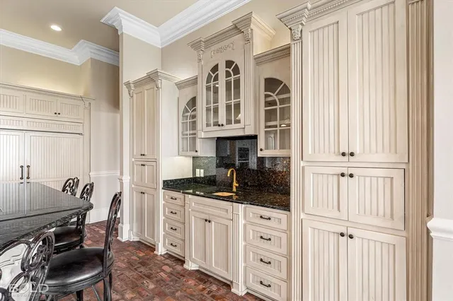 a kitchen with cabinets appliances and a window