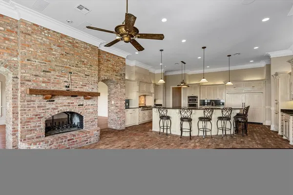 a living room with furniture a fireplace and kitchen view