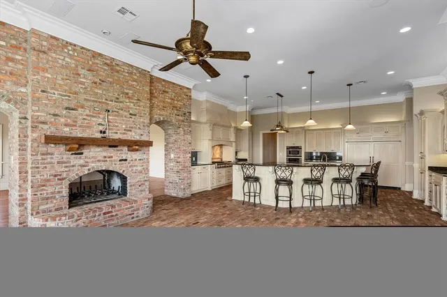 a living room with furniture a fireplace and kitchen view