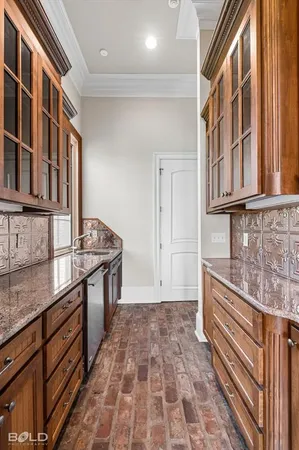 a kitchen with stainless steel appliances granite countertop a stove and cabinets