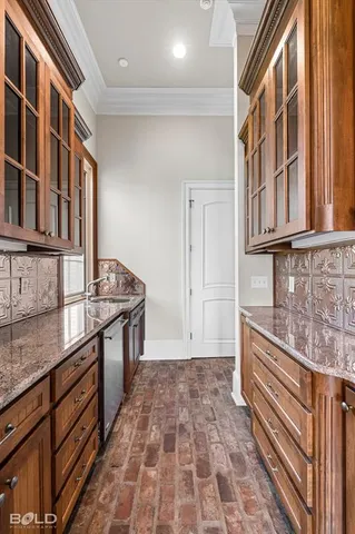 a kitchen with stainless steel appliances granite countertop a stove and cabinets
