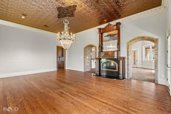 a living room with fireplace furniture and a chandelier