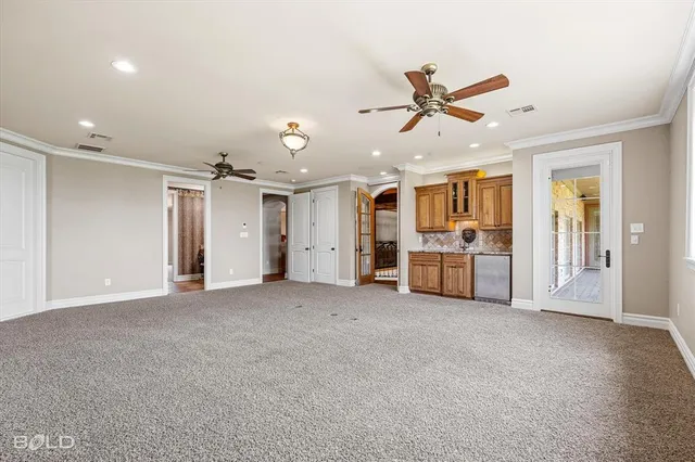 a view of a livingroom with furniture and a kitchen