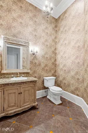 a bathroom with a granite countertop toilet a sink and a mirror